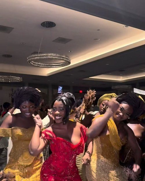 Guests dancing in kente and gold