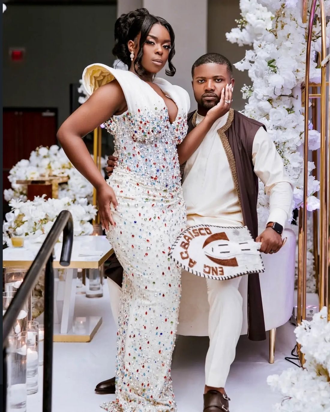 A couple arriving in traditional ceremony attire